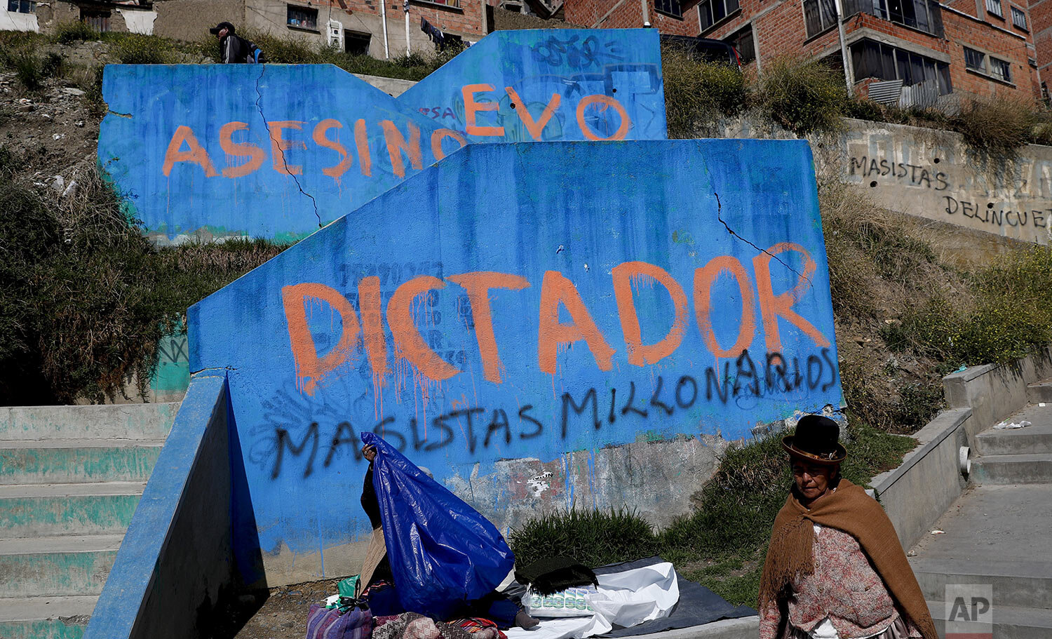  Graffiti against Bolivia's former President Evo Morales that reads in Spanish "Evo murderer, dictator" covers the entrance to a neighborhood in La Paz, Bolivia, Dec. 3, 2019. Morales held office for nearly 14 years, starting in 2006, and twice won r