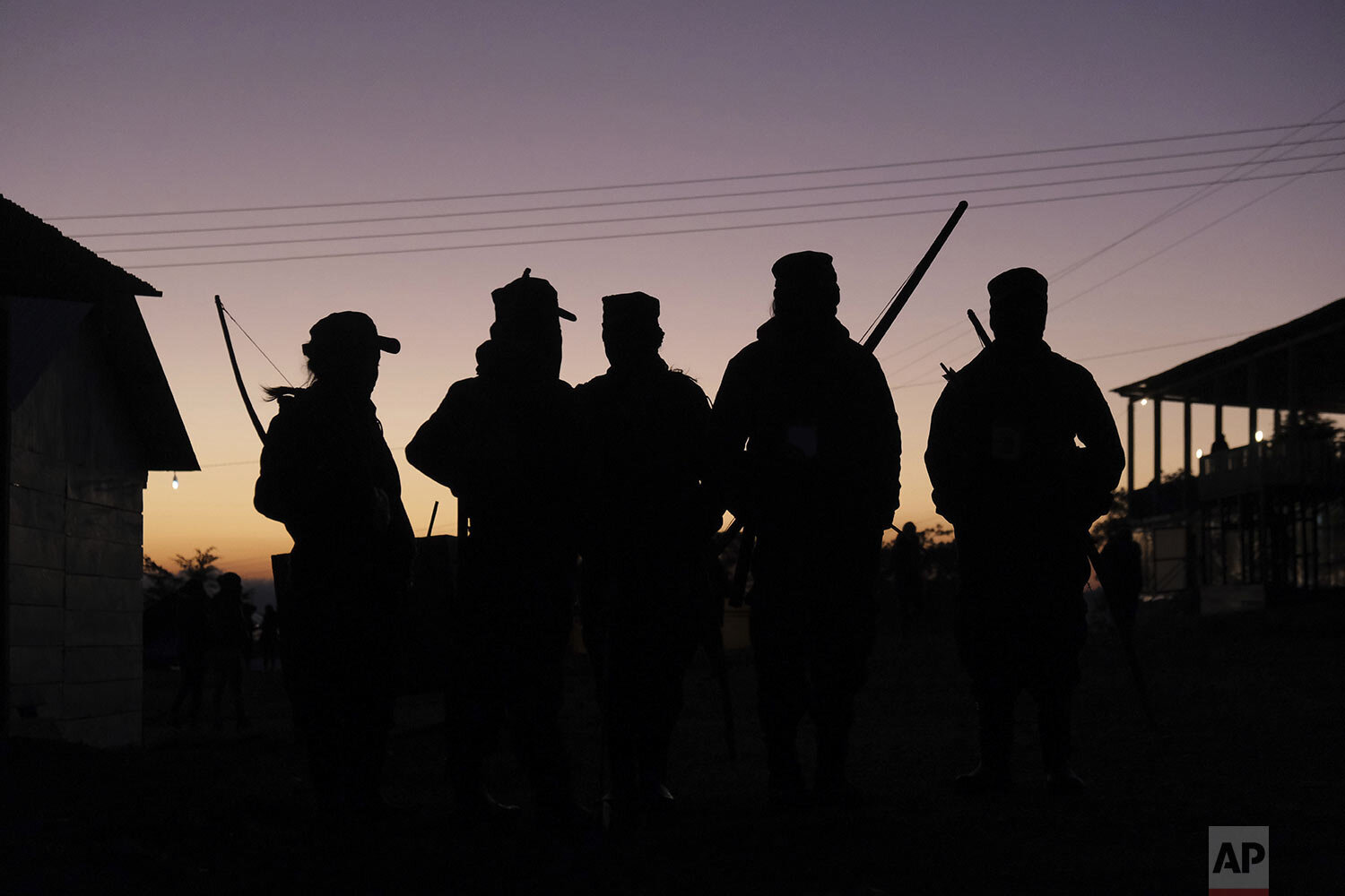  Female members of the Zapatista militia, carrying bows and arrows, wait for coffee at sunrise during a gathering titled The Second International Meeting of Women Who Fight, organized by the women of the Zapatista National Liberation Army (EZLN) in C