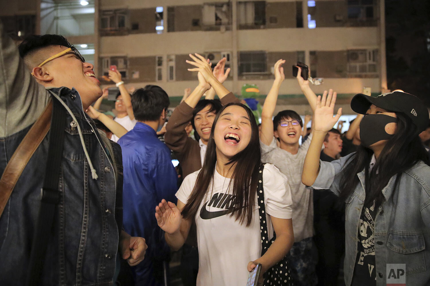  Pro-democracy supporters celebrate after pro-Beijing politician Junius Ho lost his election in Hong Kong, early Monday, Nov. 25, 2019. (AP Photo/Kin Cheung) 