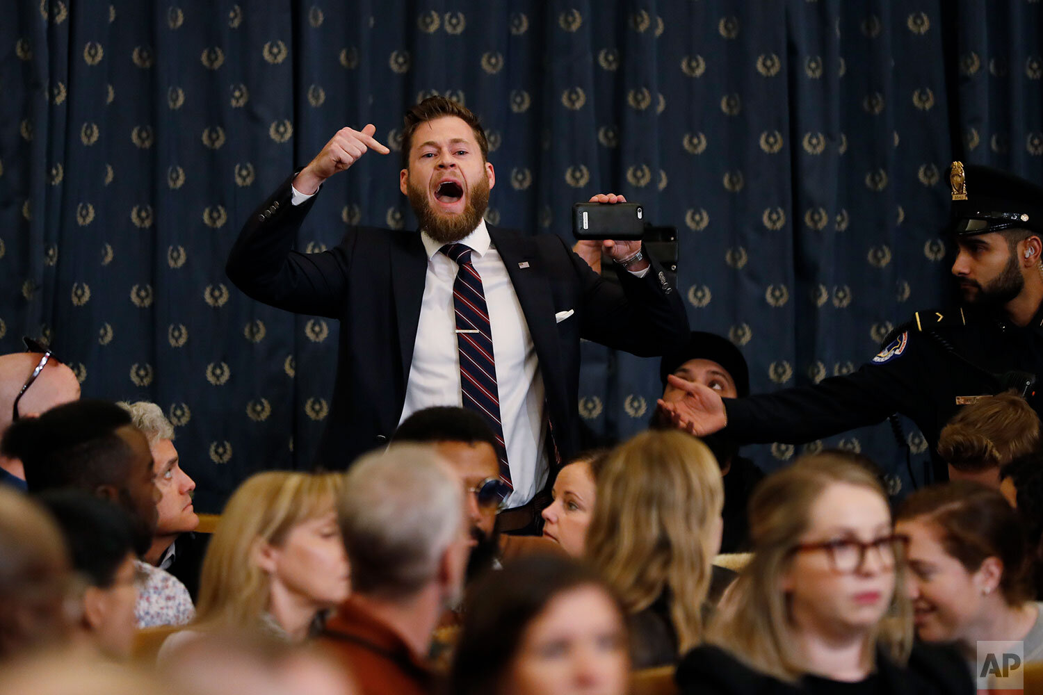  A protestor speaks out as the House Judiciary Committee hears investigative findings in the impeachment inquiry of President Donald Trump, Monday, Dec. 9, 2019, on Capitol Hill in Washington. (AP Photo/Andrew Harnik) 