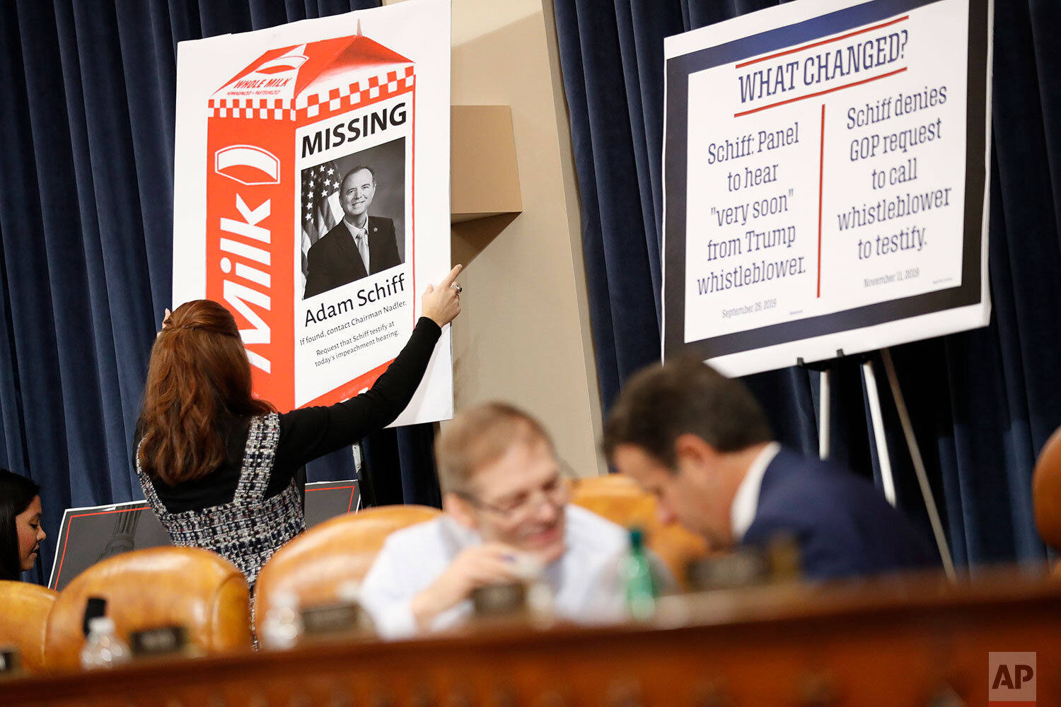  House Judiciary Committee staff members place signs during a break in the hearing room where the committee hears investigative findings in the impeachment inquiry of President Donald Trump, Monday, Dec. 9, 2019, on Capitol Hill in Washington. (AP Ph