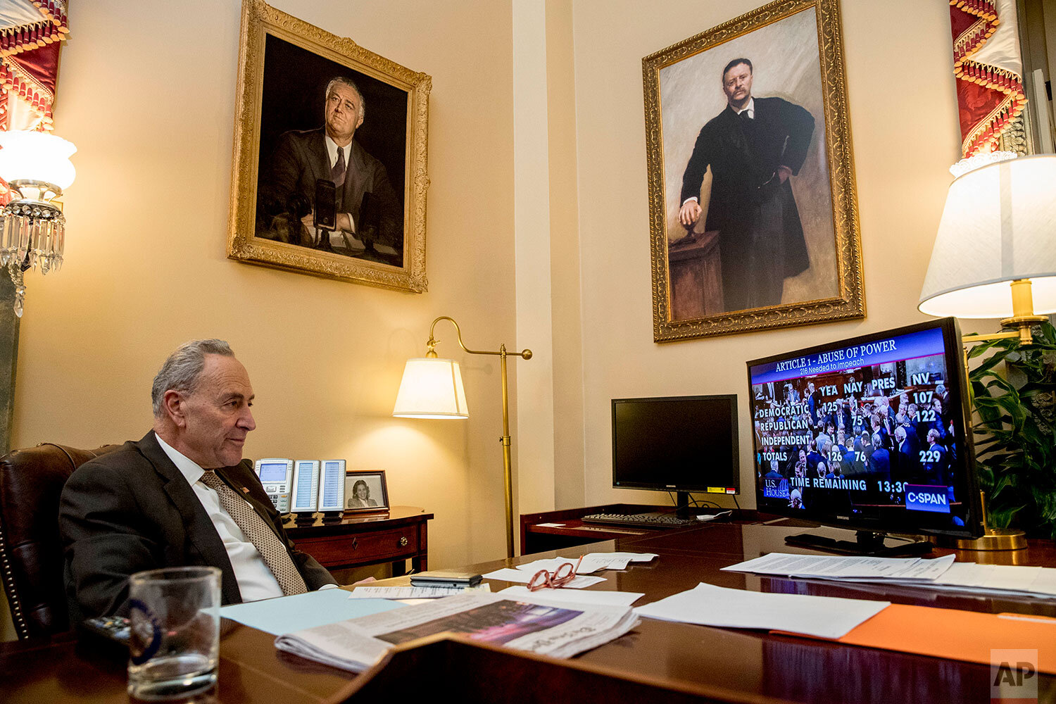  Senate Minority Leader Sen. Chuck Schumer of N.Y., watches from his Senate office as the House votes on the articles of impeachment President Donald Trump, Wednesday, Dec. 18, 2019, on Capitol Hill in Washington. (AP Photo/Andrew Harnik) 