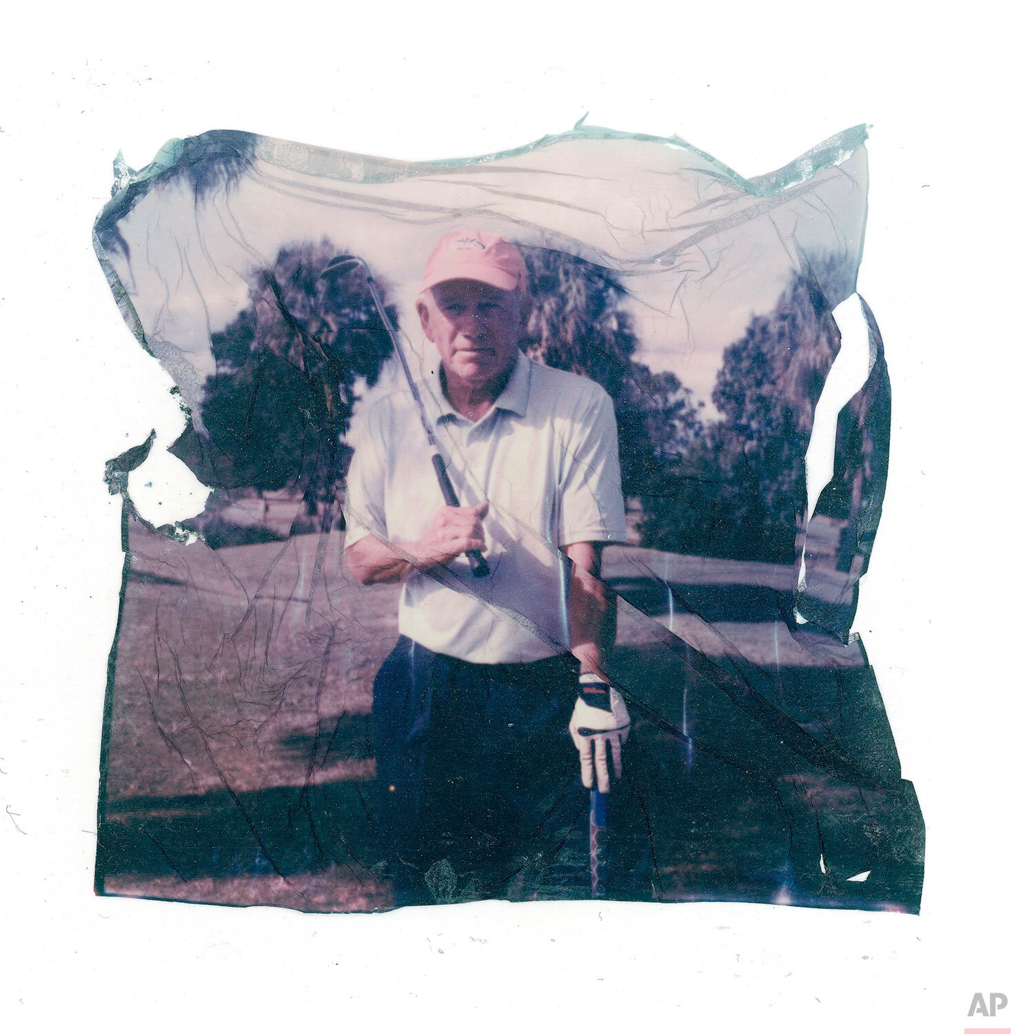  In this image made from a Polaroid emulsion transfer, John Vai, 67, a survivor of clergy abuse poses for a photo on the golf course in The Villages, Fl., Friday, Nov. 22, 2019. He plays golf each day, part of a routine that helps keep dark memories 