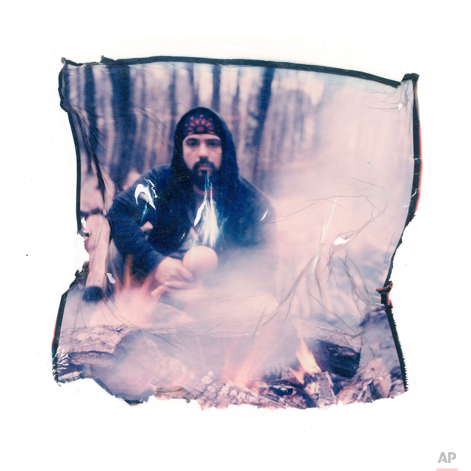  In this image made from a Polaroid emulsion transfer, Salvador Bolivar, 48, prays in front of a fire before a sweat lodge ceremony on Sunday Oct. 27, 2019, in New York. Bolivar, a survivor of clergy abuse says his spirituality and journey to help ot