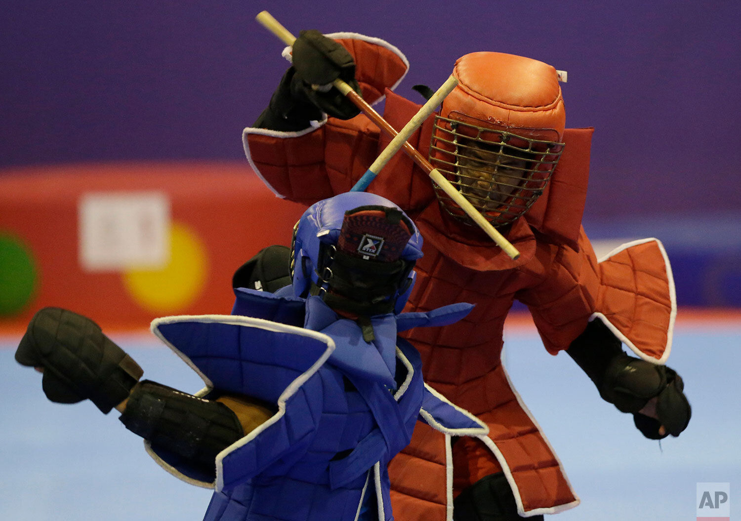  Philippine's's Villardo Cunamay, in blue, competes against Cambodia's Mengly Yong, in red, during their men's light weight +60kg final arnis match at the 30th Southeast Asian Games at the Clark City, Tarlac province, northern Philippines on Sunday, 