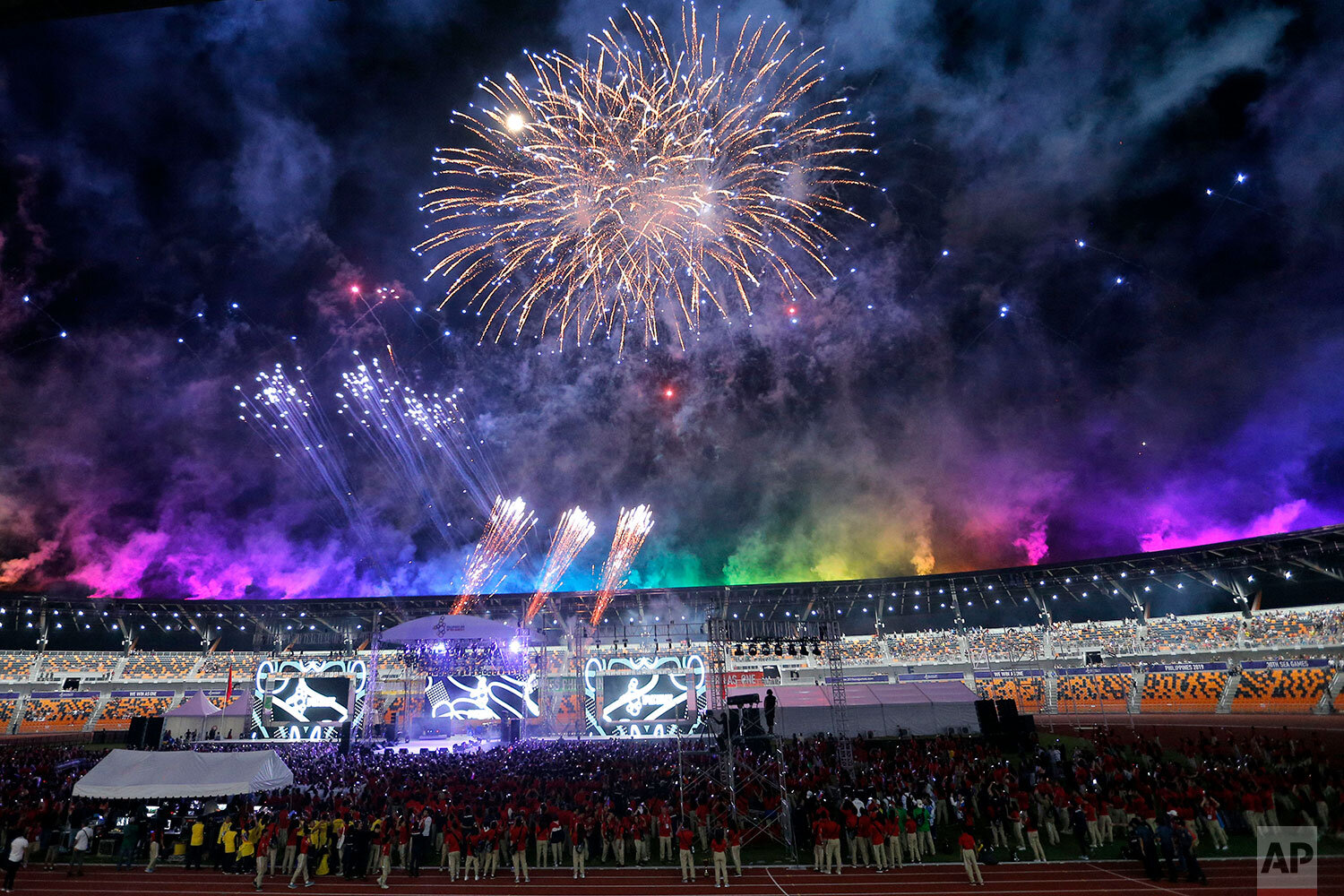  Athletes and spectators watch during a fireworks display at the closing ceremony of the 30th South East Asian Games at New Clark City, Tarlac province, northern Philippines on Wednesday Dec. 11, 2019. Vietnam will host the next SEA Games on 2021. (A