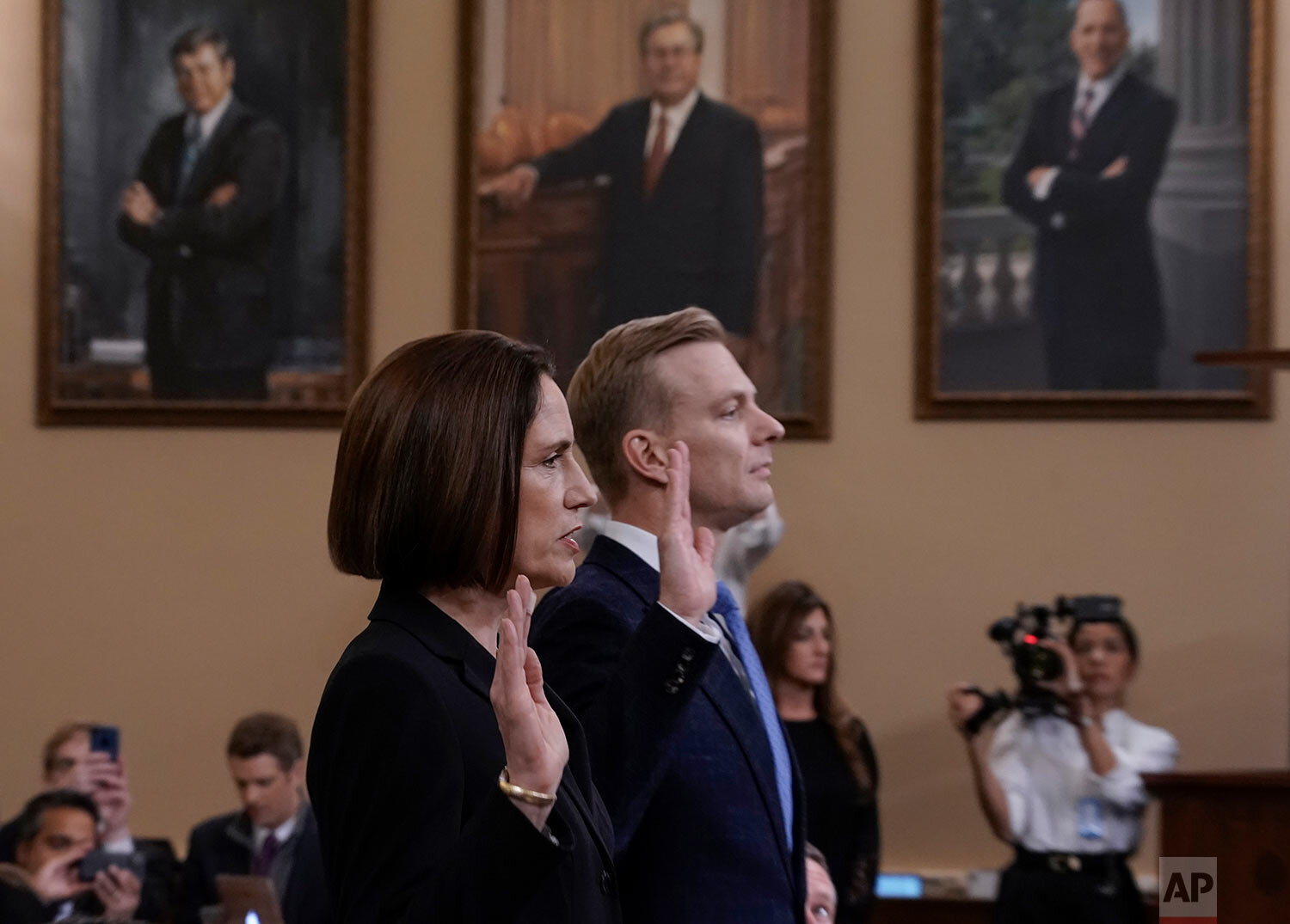  Former White House national security aide Fiona Hill, left, and David Holmes, a U.S. diplomat in Ukraine, are sworn in to testify before the House Intelligence Committee on Capitol Hill in Washington, Thursday, Nov. 21, 2019, during a public impeach