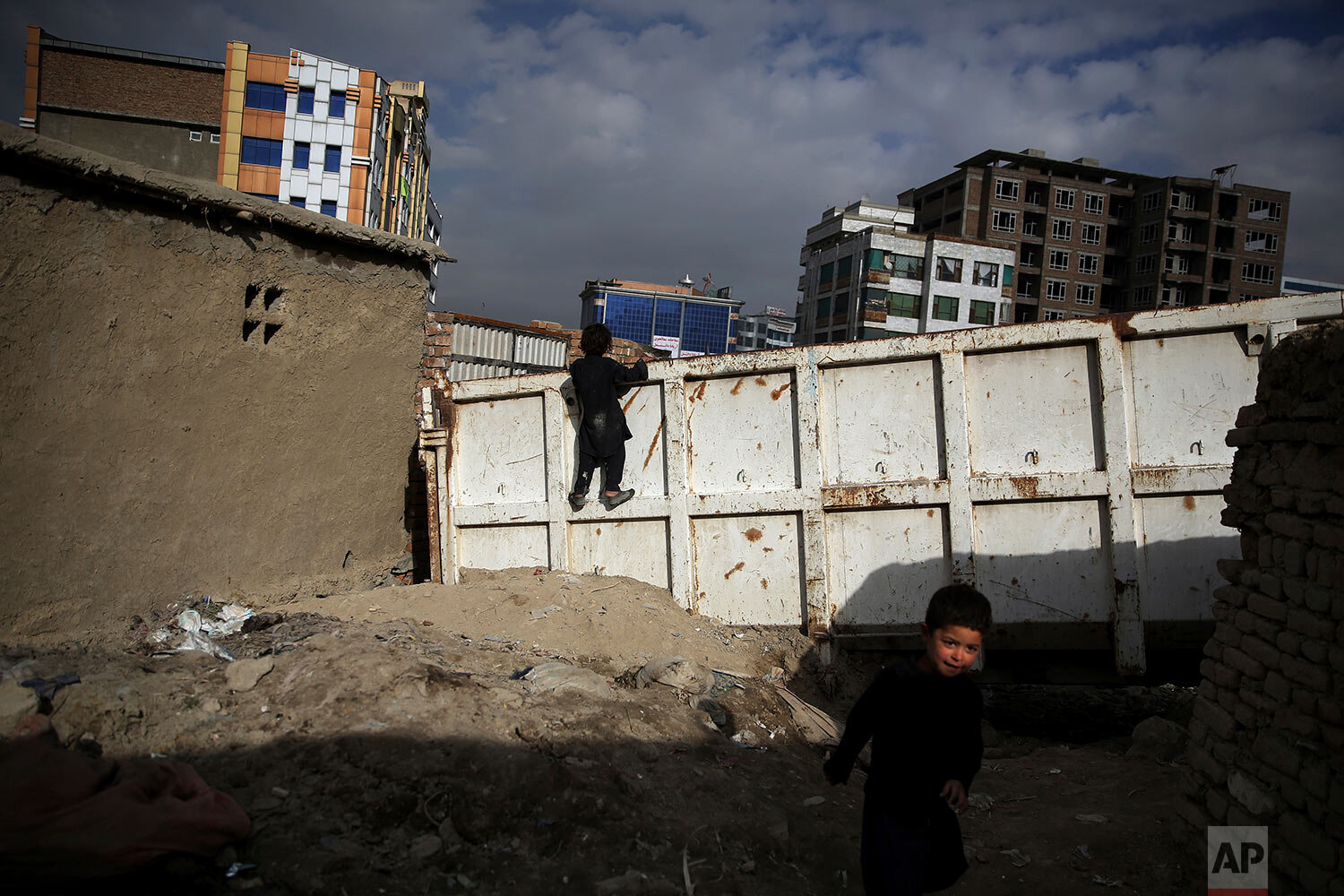  Boys play at a camp for internally displaced people in Kabul, Afghanistan, Monday, Dec. 9, 2019. Tens of thousands of internally displaced Afghans live in camps, which lack basic facilities, across Afghanistan. (AP Photo/Altaf Qadri) 