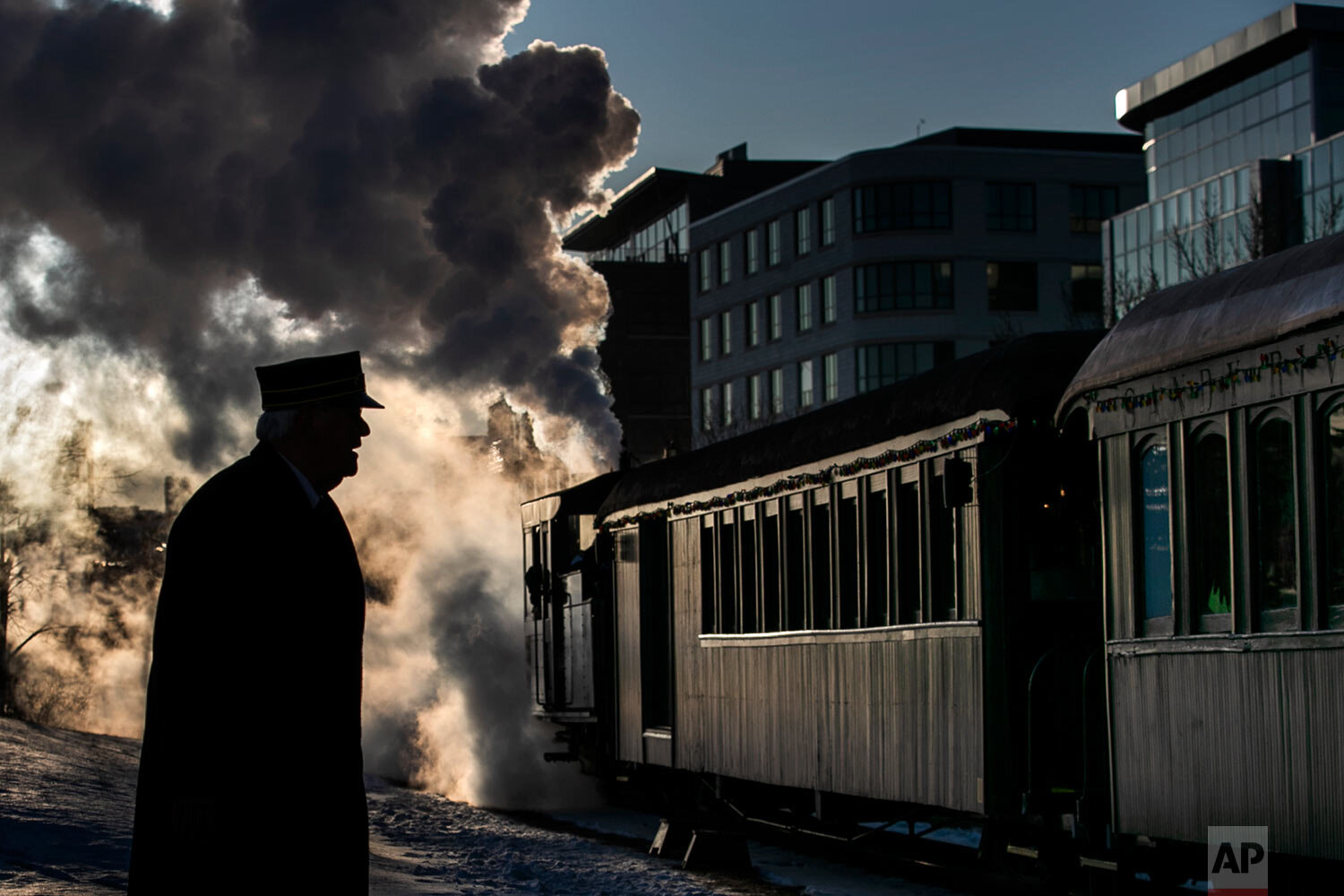  Steam billows from a locomotive as The Polar Express departs for the "North Pole" under the watch of conductor Jerry Angier, Friday, Dec. 20, 2019, in Portland, Maine. The annual holiday journey is staffed mostly by volunteers and is the largest ann