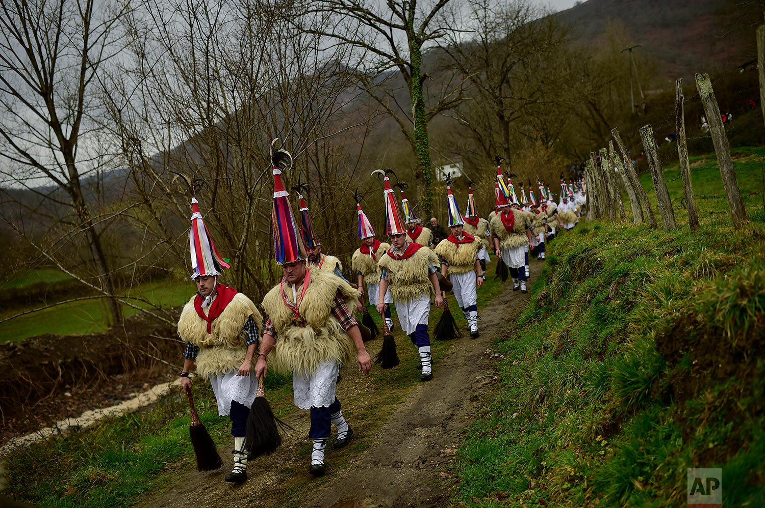  In this Monday, Jan. 27, 2020 photo, ''Joaldunak'' march along a path as they take part in a Carnival in the small Pyrenees village of Ituren, northern Spain.  (AP Photo/Alvaro Barrientos) 
