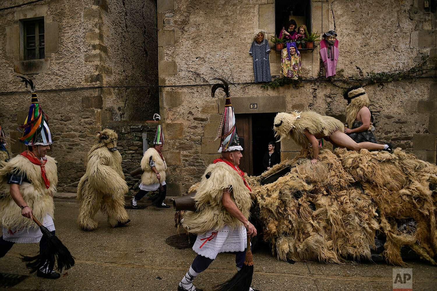  In this Monday, Jan. 27, 2020 photo, "Joaldunaks" march along the street as they take part in a Carnival in the small Pyrenees village of Ituren, northern Spain.  (AP Photo/Alvaro Barrientos) 