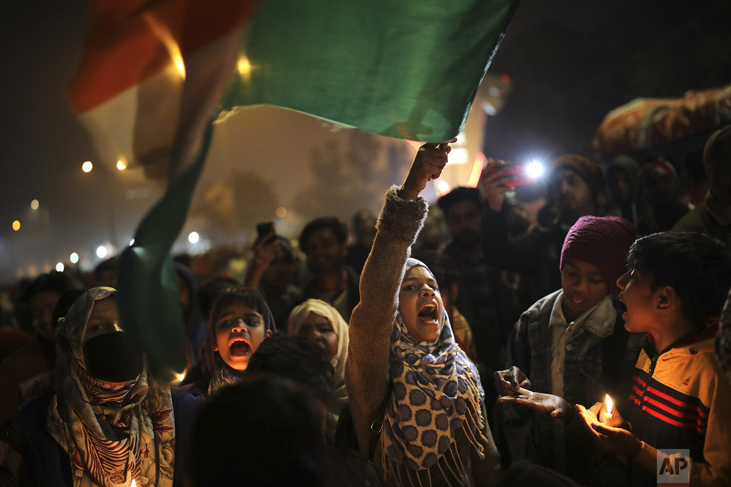  A young girl waves the Indian national flag as she shouts slogans at a protest site at Shaheen Bagh, in New Delhi, India, Tuesday, Jan. 21, 2020.   (AP Photo/Altaf Qadri) 