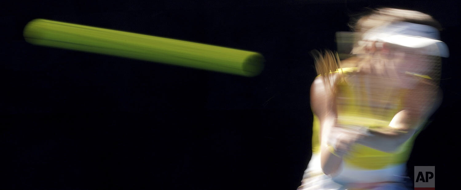  CiCi Bellis of the U.S. makes a backhand return to Belgium's Elise Mertens during their third round singles match at the Australian Open tennis championship in Melbourne, Australia, Saturday, Jan. 25, 2020. (AP Photo/Lee Jin-man) 