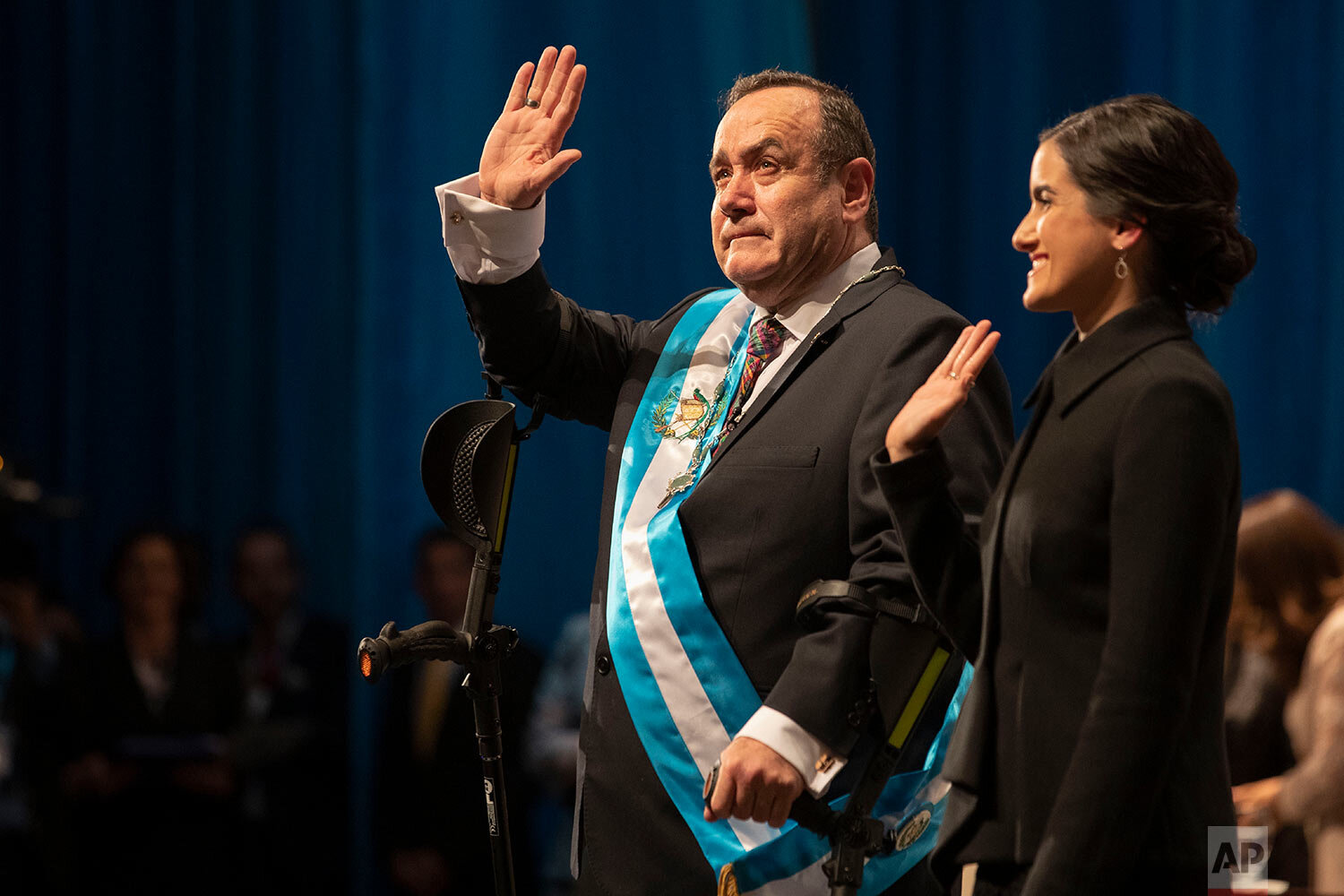  Alejandro Giammattei waves to the crowd accompanied by his daughter Ana Marcela after he was sworn-in as president of Guatemala at the National Theater in Guatemala City, Tuesday, Jan. 14, 2020. (AP Photo/Moises Castillo) 