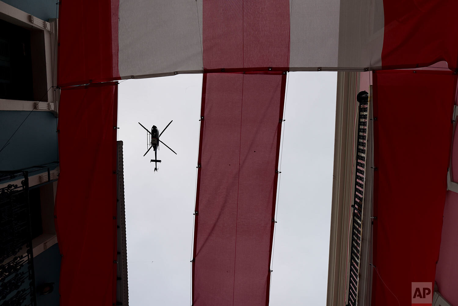  A police helicopter flies over protesters that were demanding the resignation of Governor Wanda Vazquez after the discovery of an old warehouse filled with unused emergency supplies, outside the executive mansion known has La Fortaleza, in Old San J