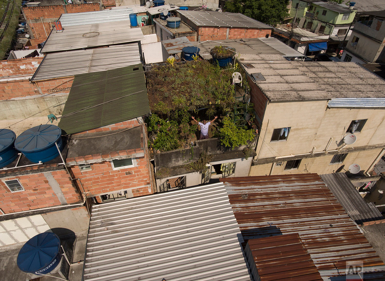  In this Jan.10, 2020 photo, Luis Cassiano shows his green roof at his home in Arara Park favela, Rio de Janeiro, Brazil. (AP Photo/Renato Spyrro) 