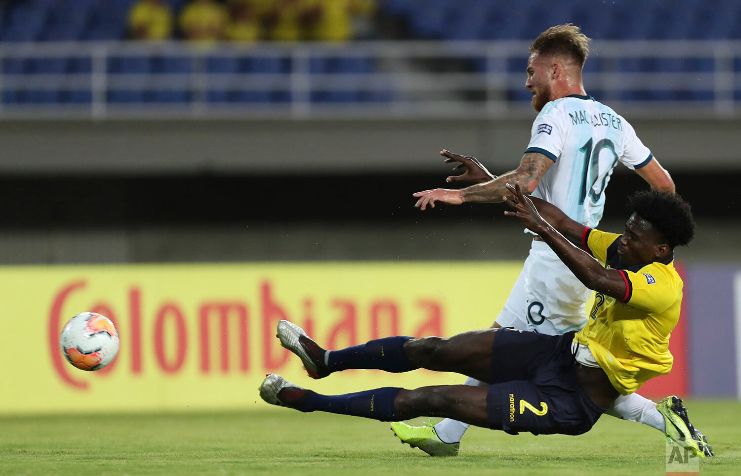  Argentina's Alexis Mac Allister, top, fights for the ball with Ecuador's Jackson Porozo during a South America Olympic qualifying U23 soccer match at the Hernan Ramirez Villegas stadium in Pereira, Colombia, Monday, Jan. 27, 2020. (AP Photo/Fernando