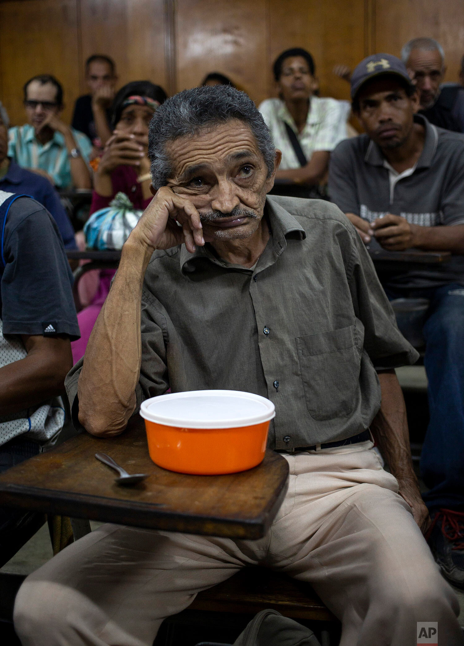  In this Feb. 27, 2020 photo, Orlando Blanco, 68, waits for food to be served at a religion center in The Cemetery slum in Caracas, Venezuela. (AP Photo/Ariana Cubillos) 