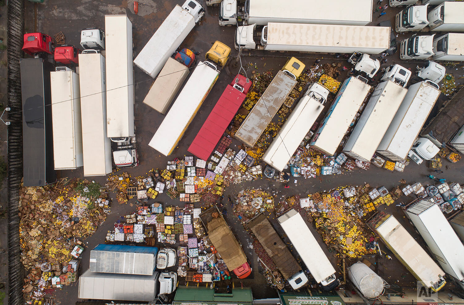  Spoiled fruit and vegetables are strewn across the CEAGESP flooded complex in Sao Paulo, Brazil, Tuesday, Feb. 11, 2020. (AP Photo/Andre Penner) 