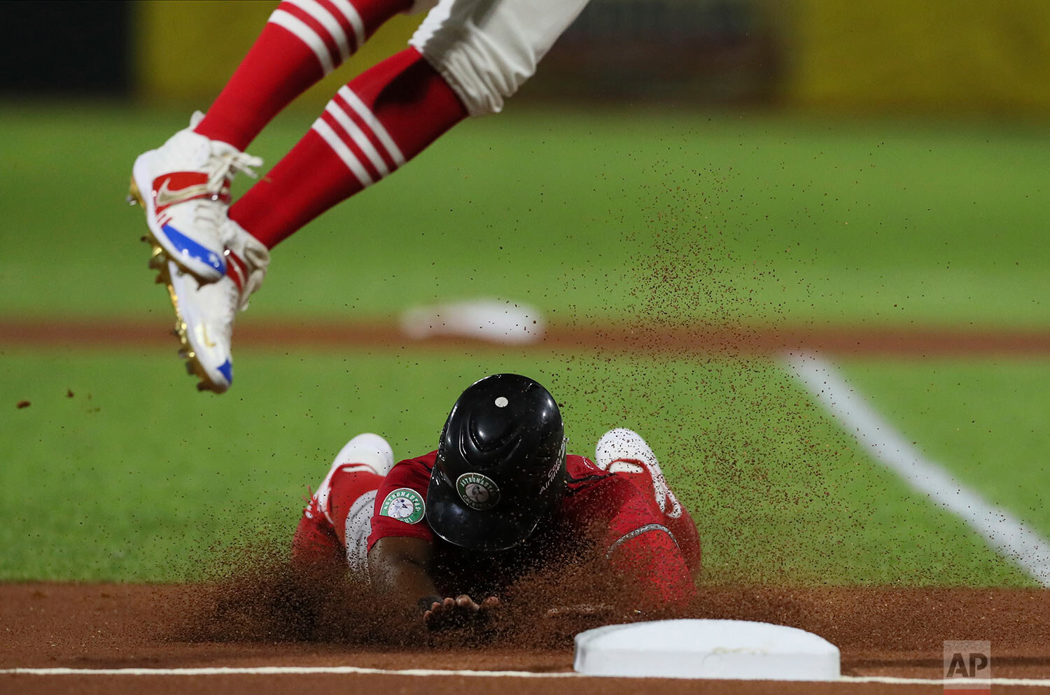  Panama's Rodrigo Orozco slides in safe at third base during a Caribbean Series baseball game against Puerto Rico in San Juan, Puerto Rico, Saturday, Feb. 1, 2020. (AP Photo/Fernando Llano) 