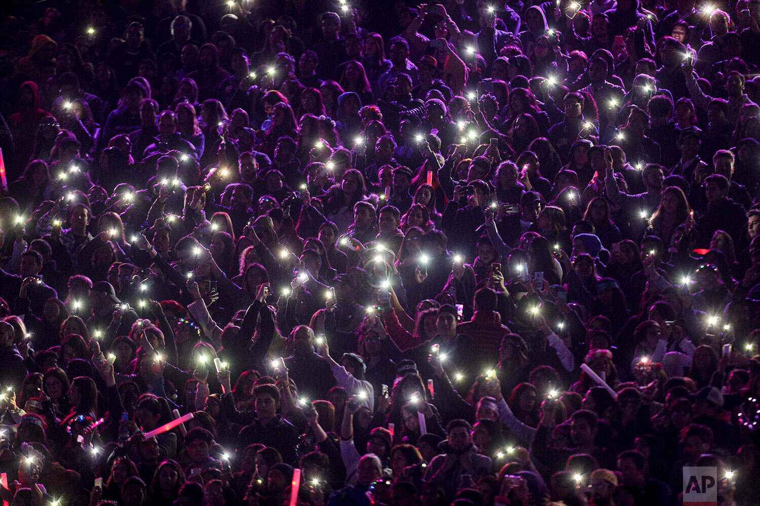  Fans of Maroon 5 shine their mobile phones during the show at the Vina del Mar International Song Festival at the Quinta Vergara coliseum in Vina del Mar, Chile, Wednesday, Feb. 27, 2020. (AP Photo/Esteban Felix) 