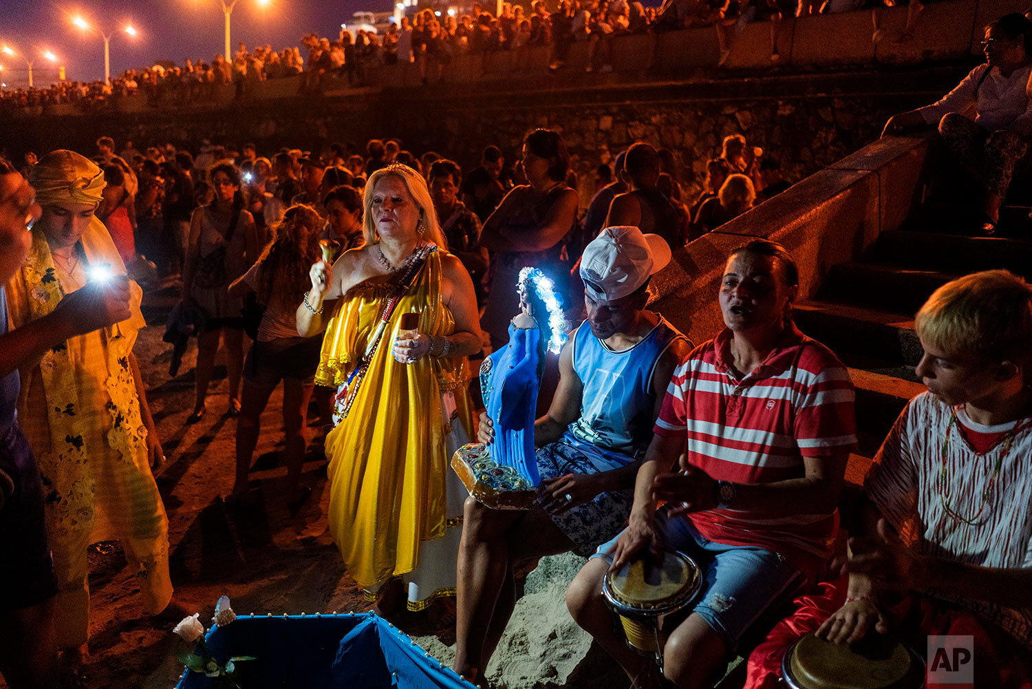  People participate in a ritual for the African sea goddess Yemanja, at a beach in Montevideo, Uruguay, Sunday, Feb. 2, 2020. (AP Photo/Matilde Campodonico) 