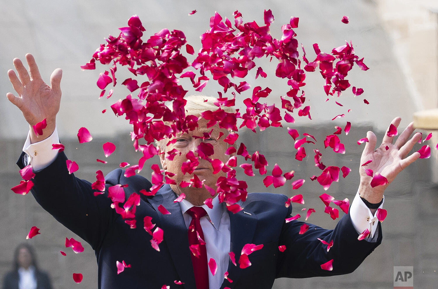 U.S. President Donald Trump offers floral respects at Raj Ghat, the memorial for Mahatma Gandhi, in New Delhi, India, Tuesday, Feb. 25, 2020. (AP Photo/Alex Brandon)