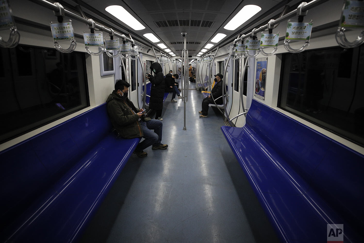 Commuters ride in a quiet subway train during the morning rush hour in Beijing, Monday, Feb. 17, 2020. (AP Photo/Andy Wong)