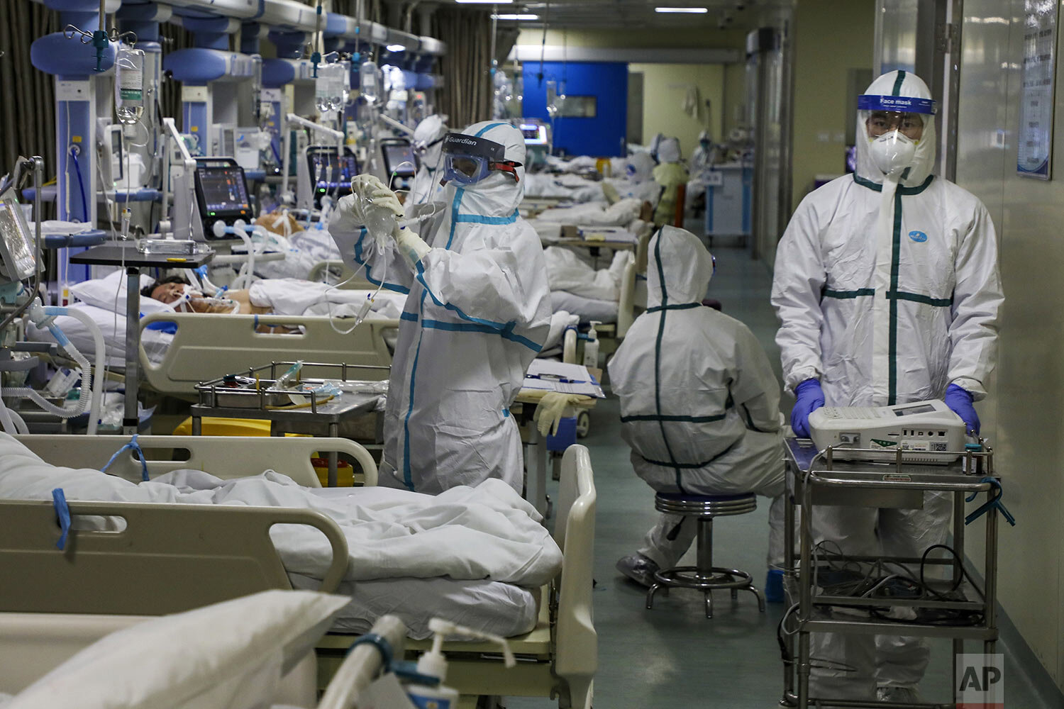 Medical workers treat patients in the isolated intensive care unit at a hospital in Wuhan in central China's Hubei province Thursday, Feb. 6, 2020. (Chinatopix via AP)