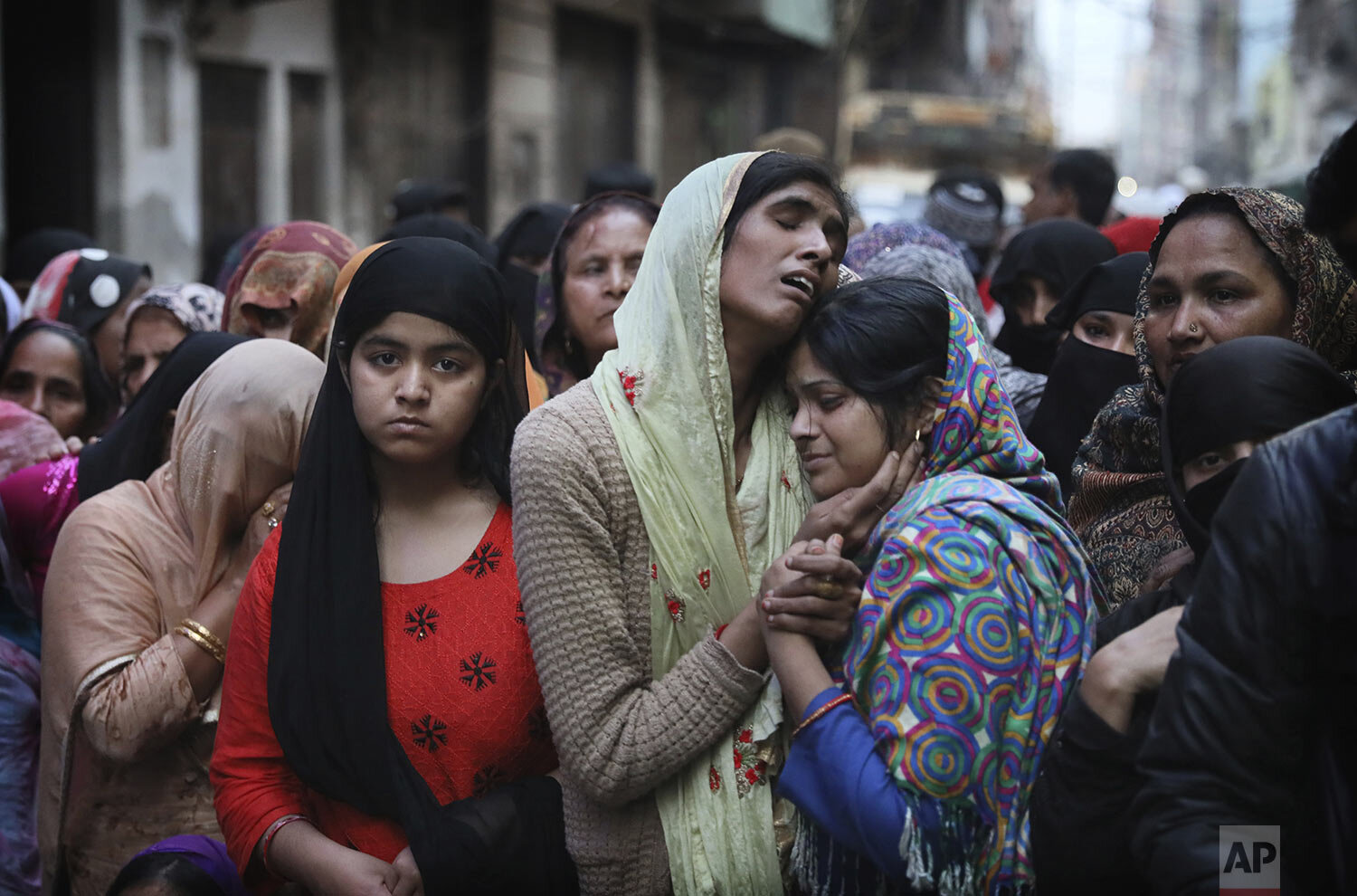 Relatives and neighbors wail near the body of Mohammad Mudasir, 31, who was killed in communal violence in New Delhi, India, Thursday, Feb. 27, 2020. (AP Photo/Manish Swarup)