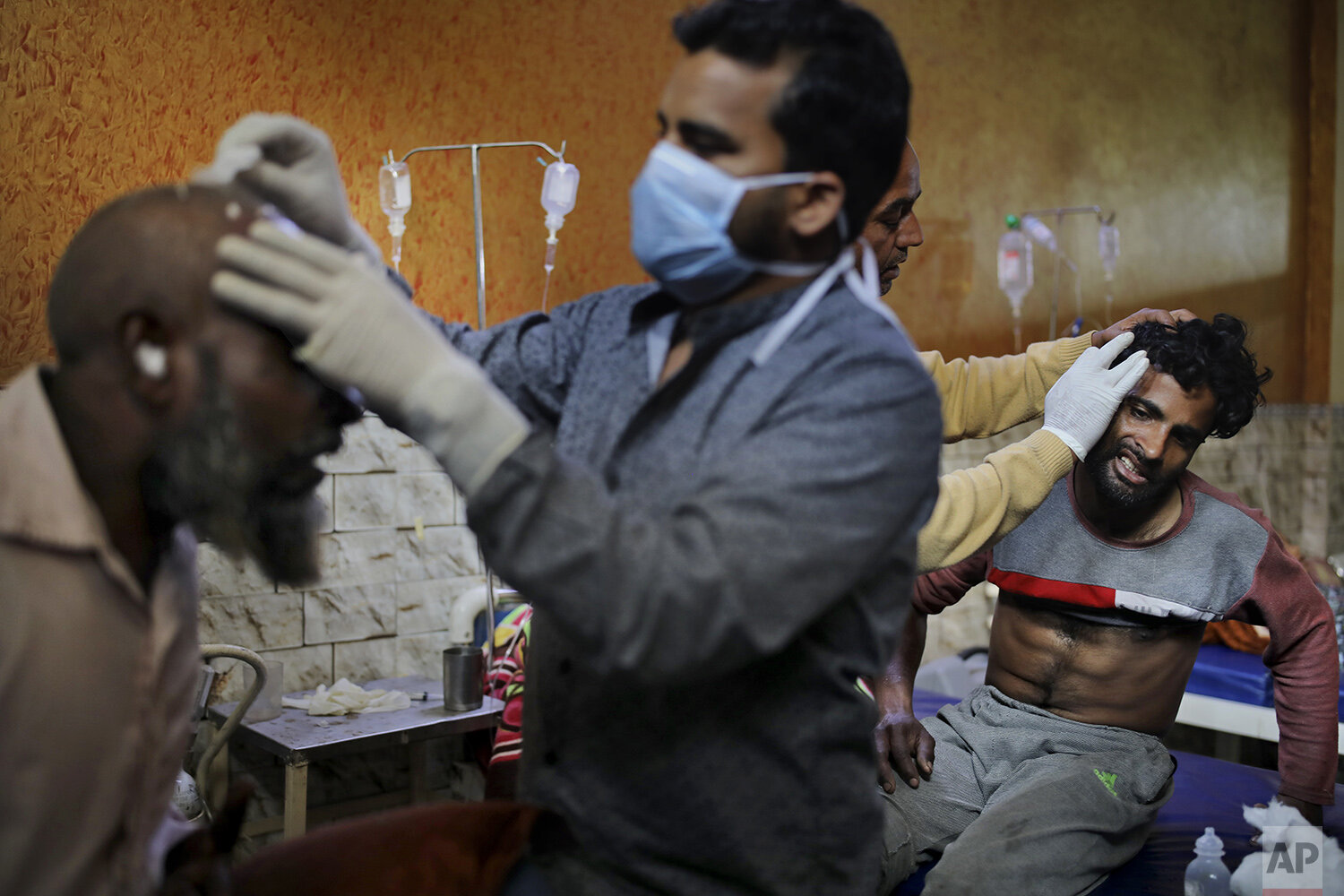  In this Friday, Feb. 28, 2020 photo, paramedics tend to the wounds of Mehfooz Umar, left, and Mohammad Afzal, right, at Al-Hind hospital in Old Mustafabad neighborhood of New Delhi, India. The hospital in the riot-torn neighborhood turned from a com