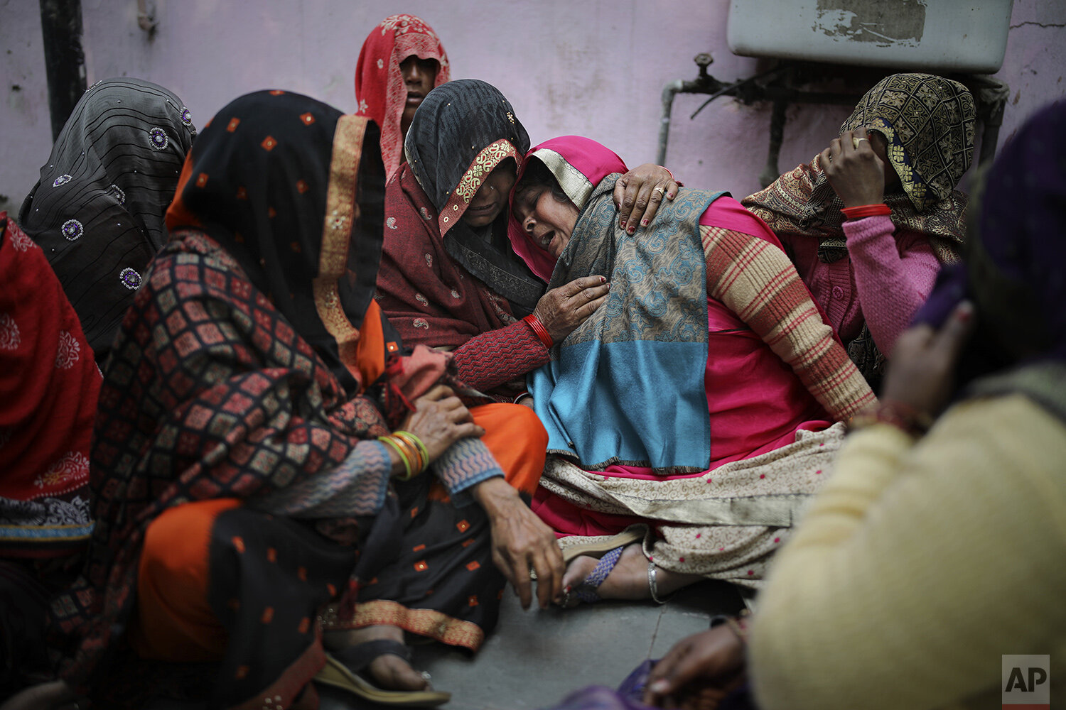  Family members of Rahul Solanki, who was killed during clashes between Hindu mobs and Muslims protesting a contentious new citizenship law, weep outside a mortuary in New Delhi, India, Wednesday, Feb. 26, 2020. At least 20 people were killed in thre