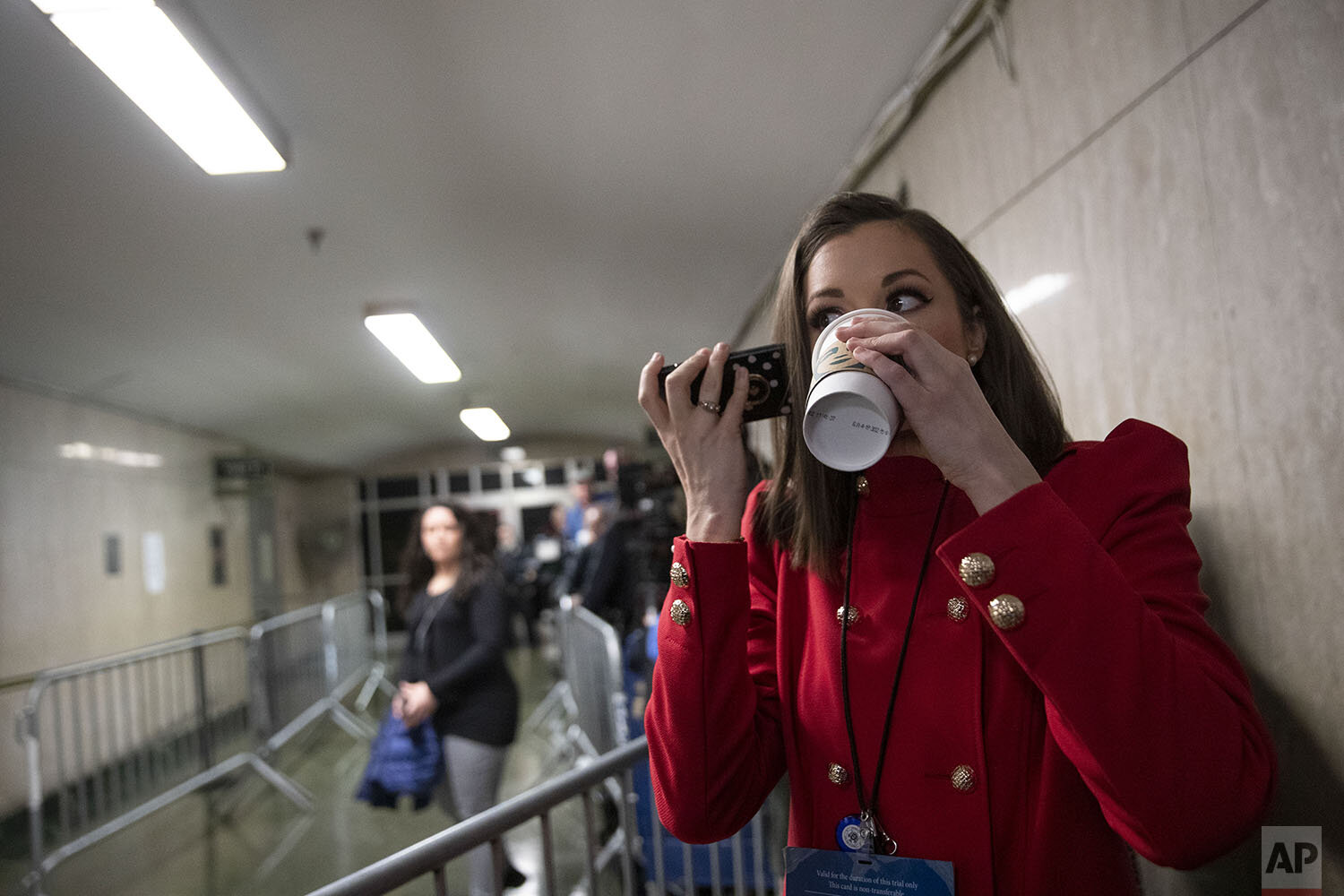  Court TV legal correspondent Chanley Painter drinks coffee and talks on he smart phone while waiting for Harvey Weinstein to arrive at a Manhattan courthouse for his rape trial, Tuesday, Feb. 18, 2020, in New York. (AP Photo/Mary Altaffer) 