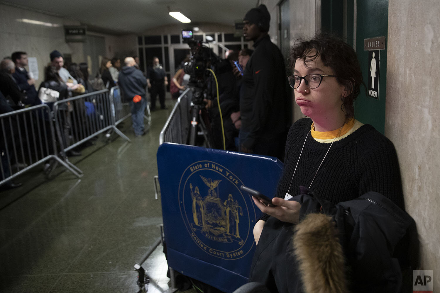  Freelance reporter working for Vulture magazine Victoria Bekiempis waits in the hallway during Harvey Weinstein’s rape trial, Tuesday, Feb. 18, 2020, in New York. (AP Photo/Mary Altaffer) 