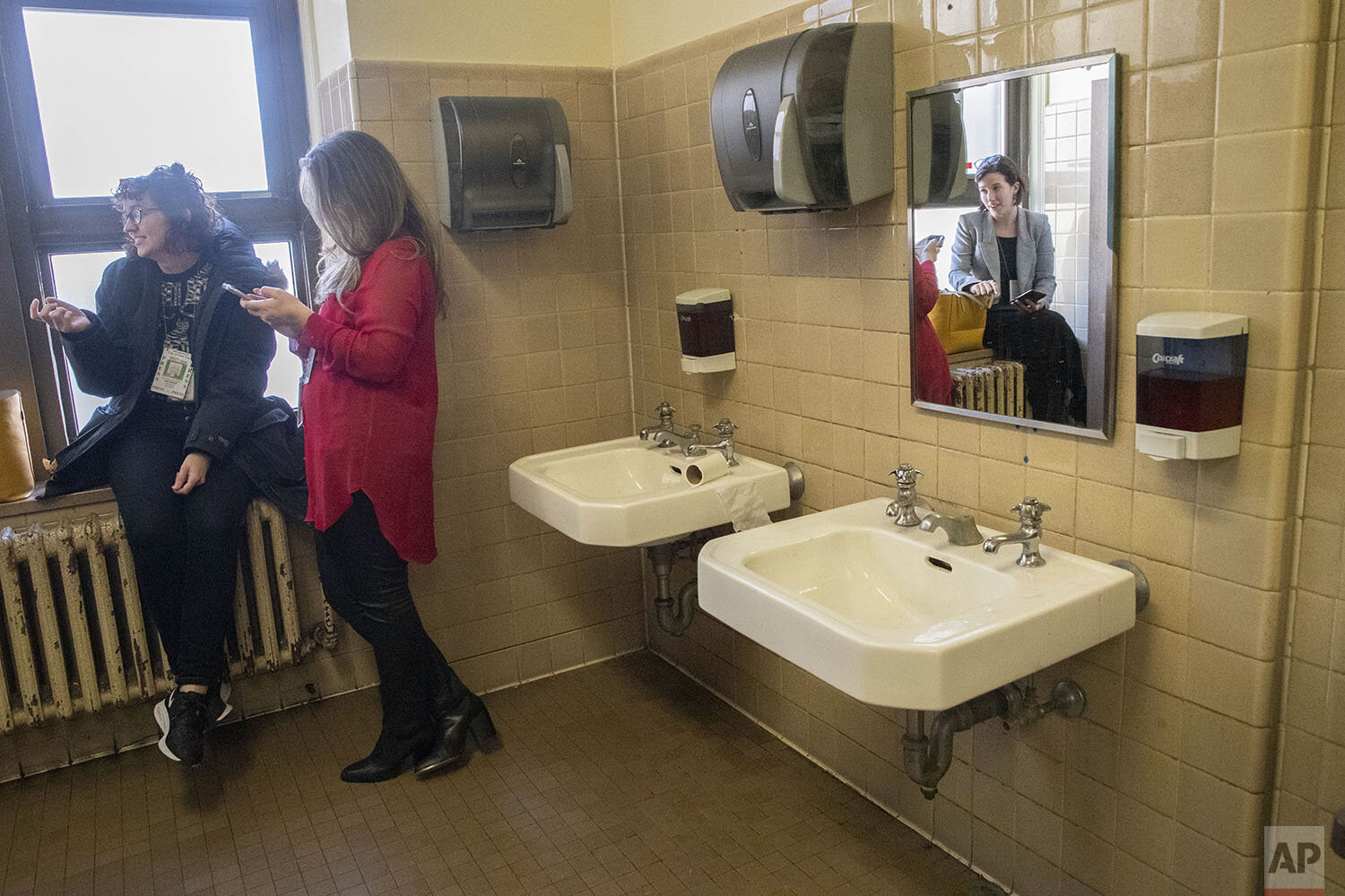  Vulture magazine freelance reporter Victoria Bekiempis, left, Fox News field producer Marta Dhanis, center, and New York Daily News reporter Molly Crane-Newman, take a break from Harvey Weinstein’s rape trial in the women’s restroom, Wednesday, Feb.