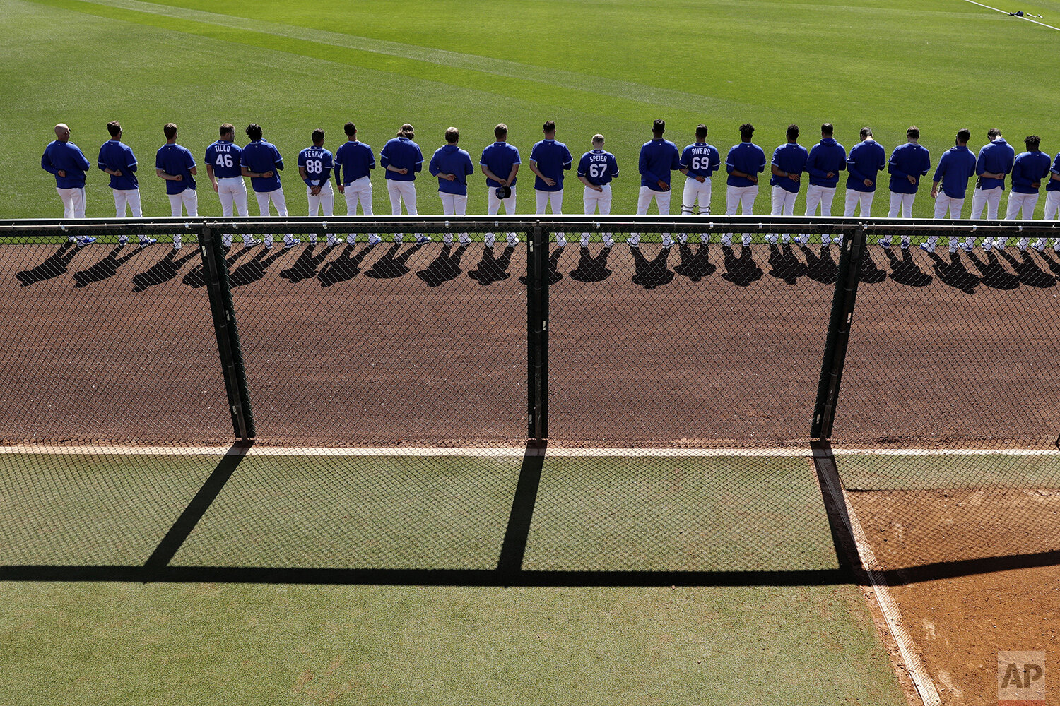  Kansas City Royals players stand for the national anthem before a spring training baseball game against the San Diego Padres Monday, Feb. 24, 2020, in Surprise, Ariz. (AP Photo/Charlie Riedel) 