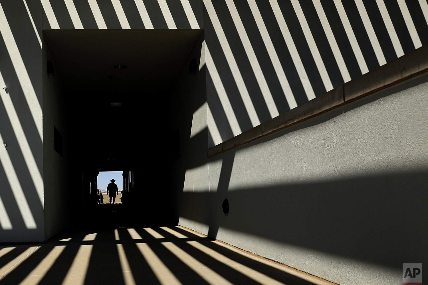  An usher walks along an upper deck concourse before a spring training baseball game between the Cleveland Indians and the San Diego Padres Wednesday, Feb. 26, 2020, in Peoria, Ariz. (AP Photo/Charlie Riedel) 