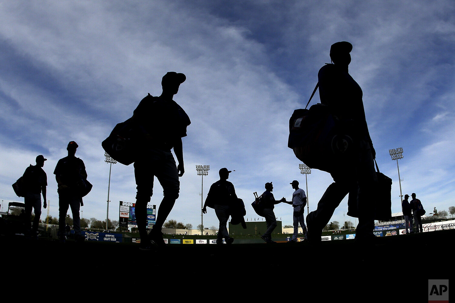  Chicago Cubs players walk to the clubhouse after a spring training baseball game against the Texas Rangers Thursday, Feb. 27, 2020, in Surprise, Ariz. The Rangers won 13-1. (AP Photo/Charlie Riedel) 