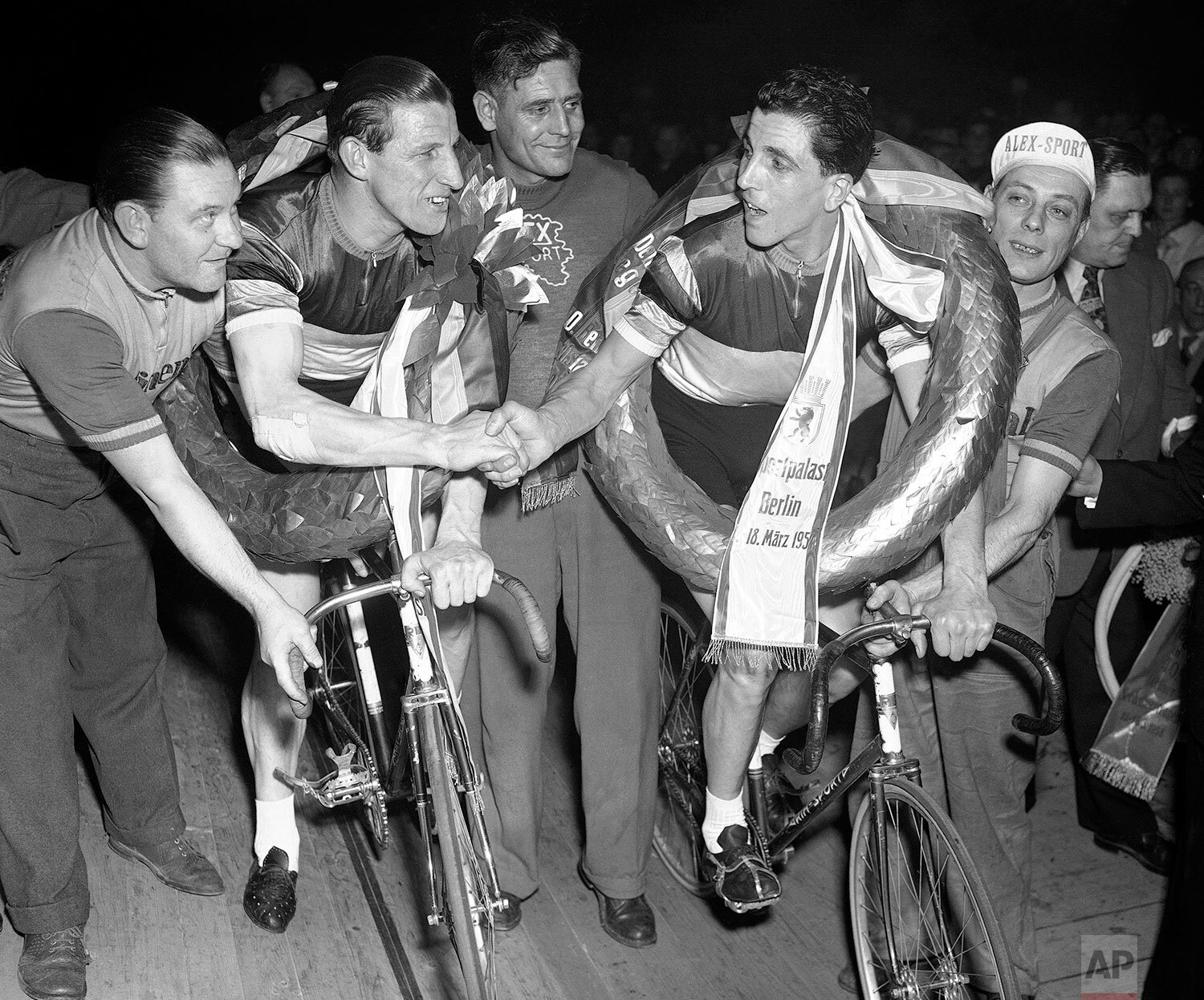  Gerrit Peters, left, and Gerrit Schulte, both of the Netherlands, shake hands after winning Berlin’s, Germany, six-day cycle race in the Sports Palace on March 18, 1954. (AP Photo/Heinrich Sanden) 