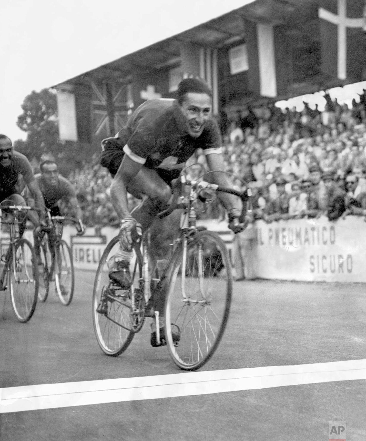  Swiss cycling legend Ferdi Kuebler wins the Street Cycling World Cup with a sprint finish in Varese, Italy, in 1951. (AP Photo) 