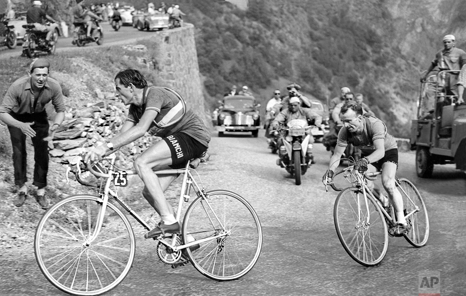  Fausto Coppi of Italy leads the pack ahead of Jean Robic of France on his way to win the 10th stage of the Tour de France cycling race from Lausanne to L'Alpe d'Huez, July 4, 1952. Coppi later won the Tour de France 1952. (AP Photo)   