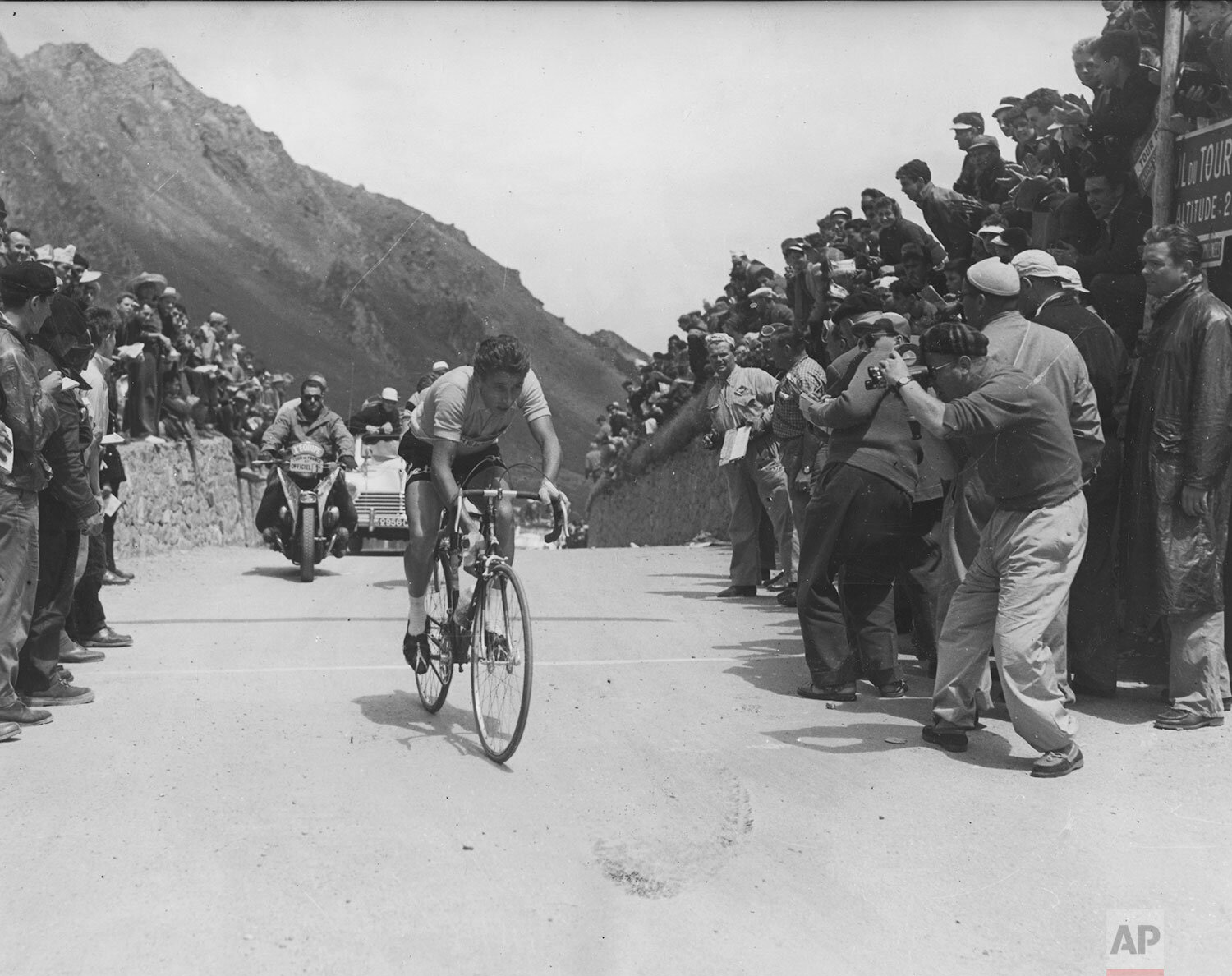  French cycling ace Jacques Anquetil still wearing the yellow jersey, reaches the 2000 meters high Tourmalet pass in the Pyrenees in Southern France, July 16, 1957, during the 18th stage of the Tour de France.  (AP Photo) 