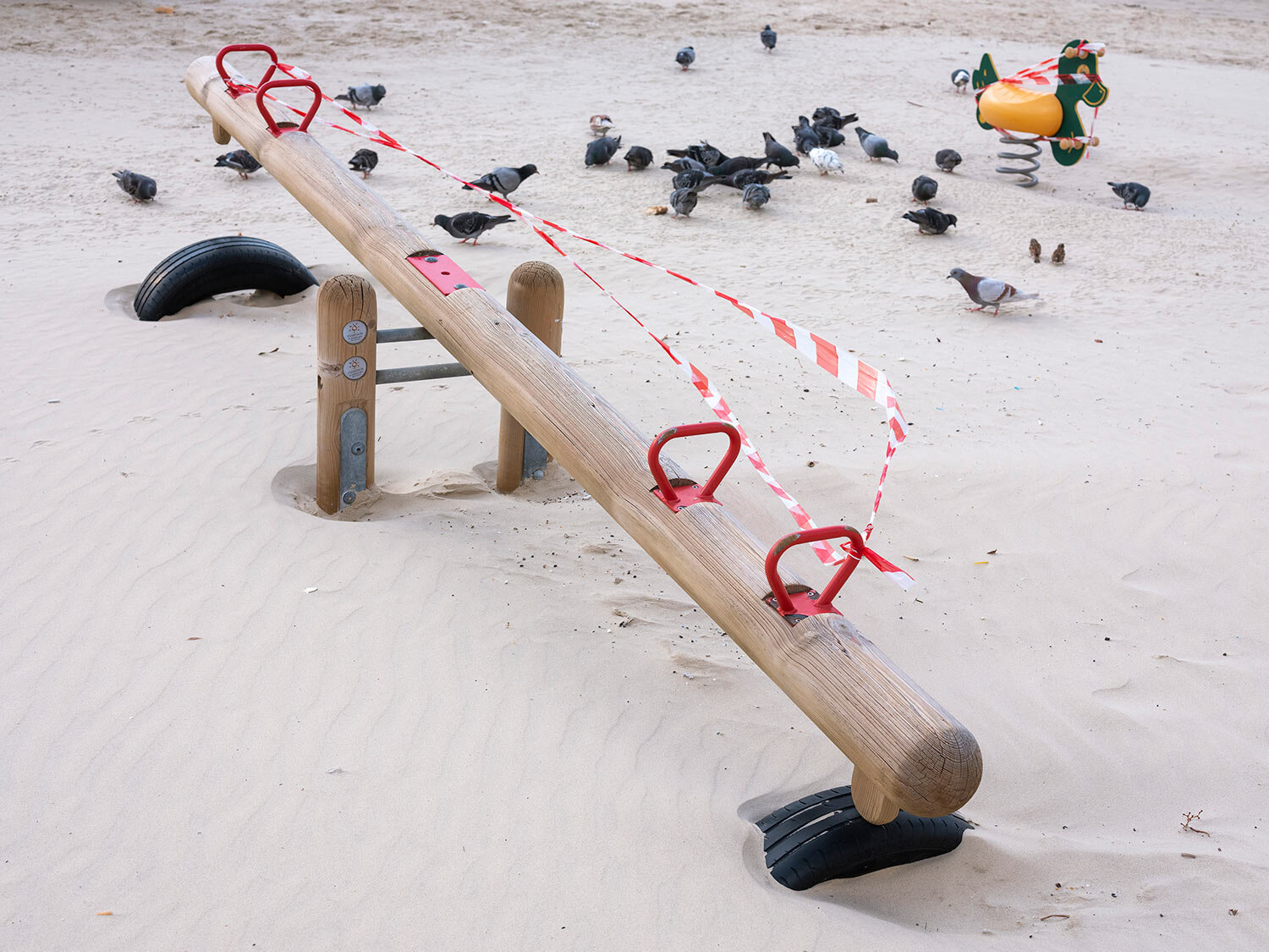  This Thursday, March 19, 2020 photo shows a seesaw at Tel Aviv's beachfront wrapped in tape to prevent public access. (AP Photo/Oded Balilty) 
