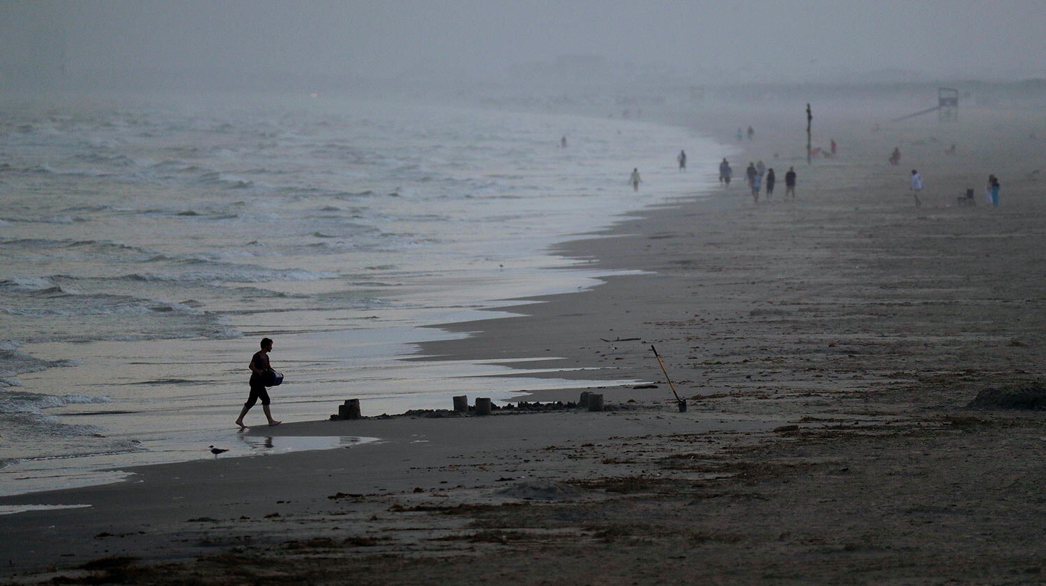  Beach goers are scattered along the water front, March 22, 2020, in Port Aransas, Texas. Officials have strongly discouraged large gatherings of spring breakers on the beach due to the coronavirus outbreak. (AP Photo/Eric Gay) 