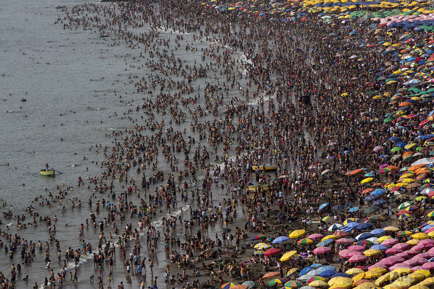  Thousands of beachgoers pack into Agua Dulce’s public beach during the Southern Hemisphere summer, which runs from December until March, in Lima, Peru, Feb. 16, 2020. (AP Photo/Rodrigo Abd)   