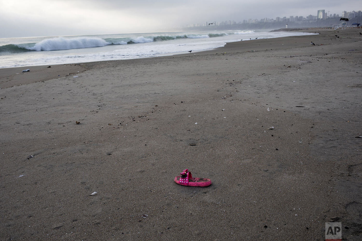  A lost sandal sits on the shore of Agua Dulce beach typically packed with thousands of beachgoers this time of year, in Lima, Peru, March 25, 2020. (AP Photo/Rodrigo Abd) 