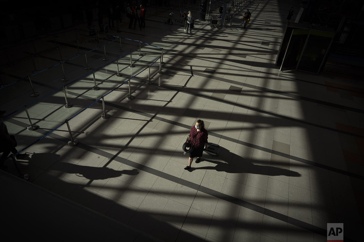  A passenger walks through an empty terminal at Ezeiza International Airport in Buenos Aires, Argentina, March 23, 2020, as most flights are canceled to help stop the spread of the new coronavirus. (AP Photo/Victor R. Caivano) 