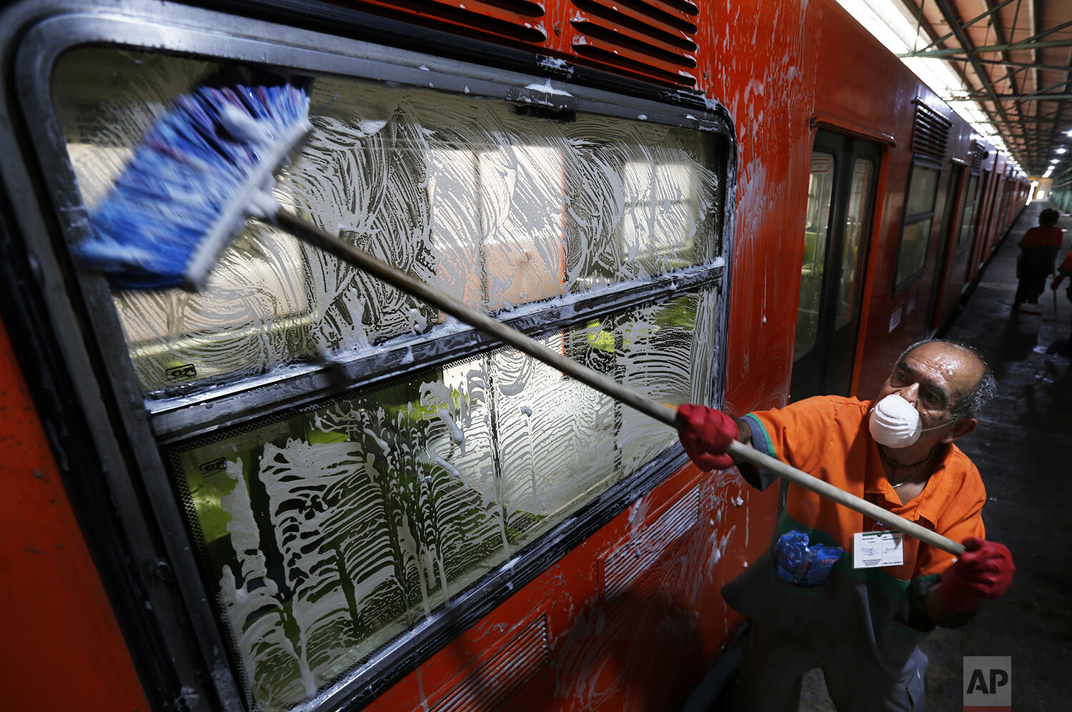  A man washes metro car as a preventive measure against the spread of the new coronavirus in Mexico City, March 18, 2020. (AP Photo/Marco Ugarte) 