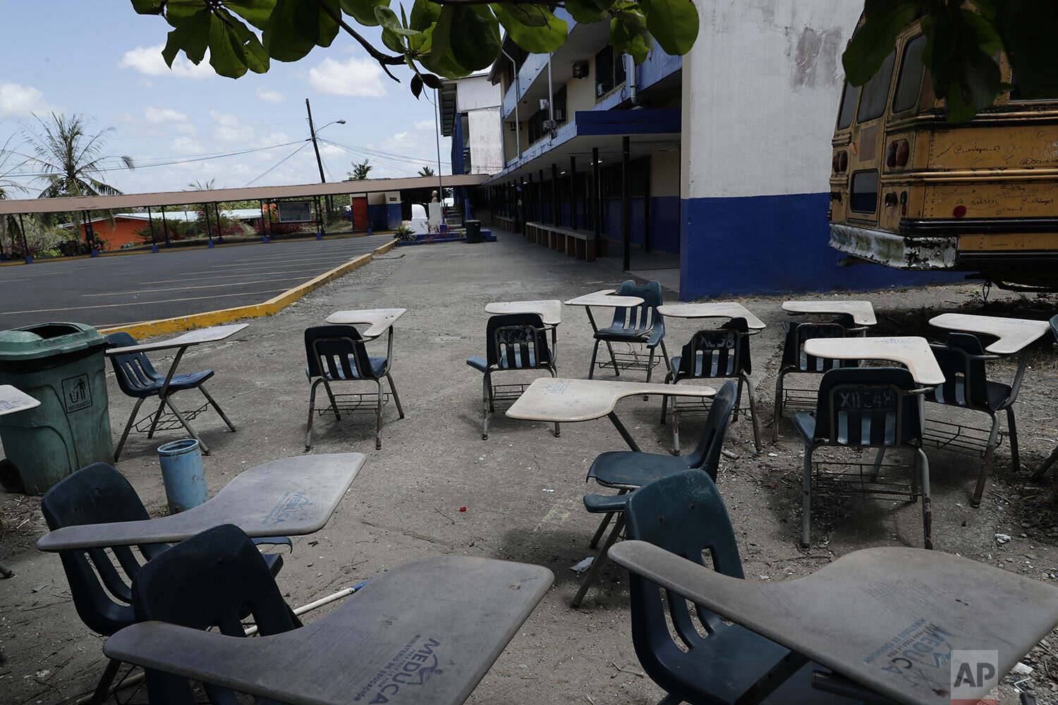  Student desks sit in the shade next to the parking lot of the closed Francisco Beckman high school, where a professor who died of the coronavirus worked, on the outskirts of Panama City, March 12, 2020, on the first day that schools closed nation-wi