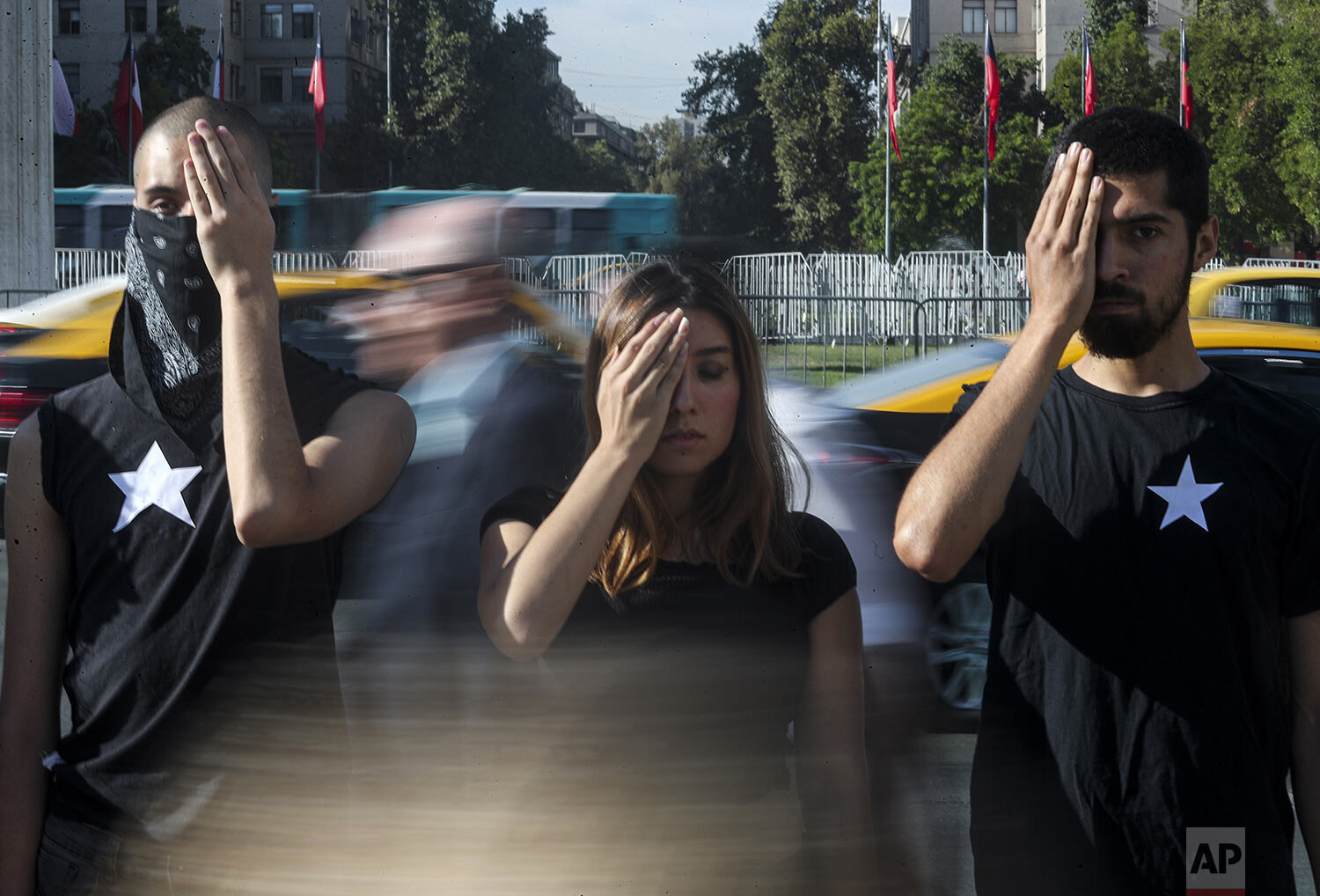  People take part in a street performance to protest President Sebastian Pinera's second year in office, outside La Moneda presidential palace in Santiago, Chile, March 11, 2020. (AP Photo/Esteban Felix) 